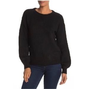 Cozy Max Studio black crew neck sweater with ribbed puffed sleeves.